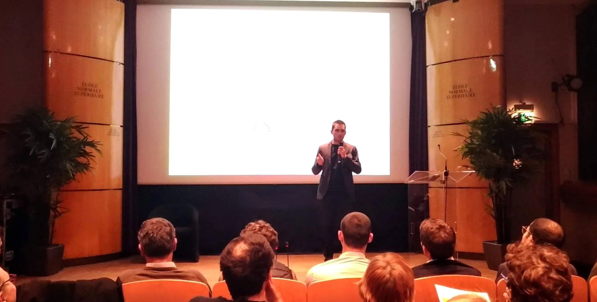Flavien speaking in front of a crowd at Ecole Normale Superieure in Paris